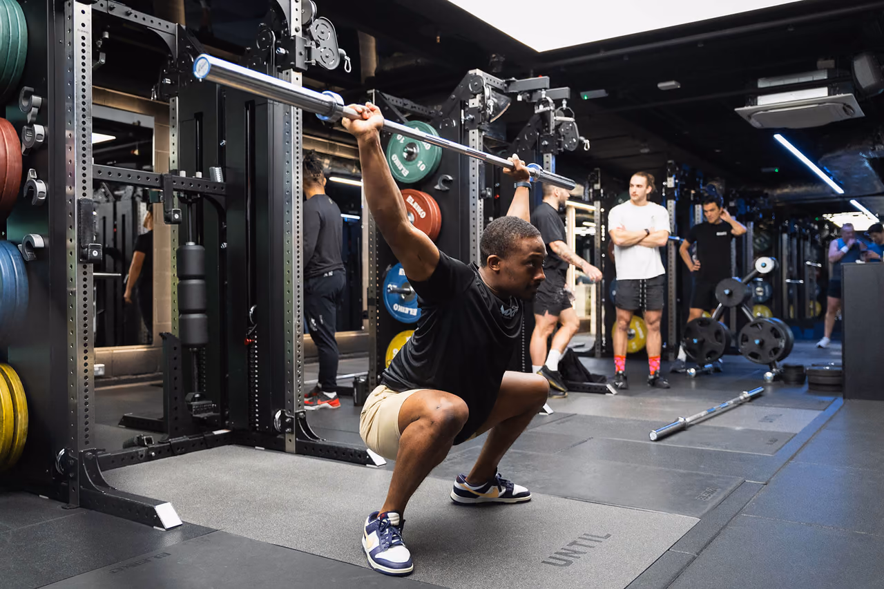 Participant practising an overhead squat at Until Soho